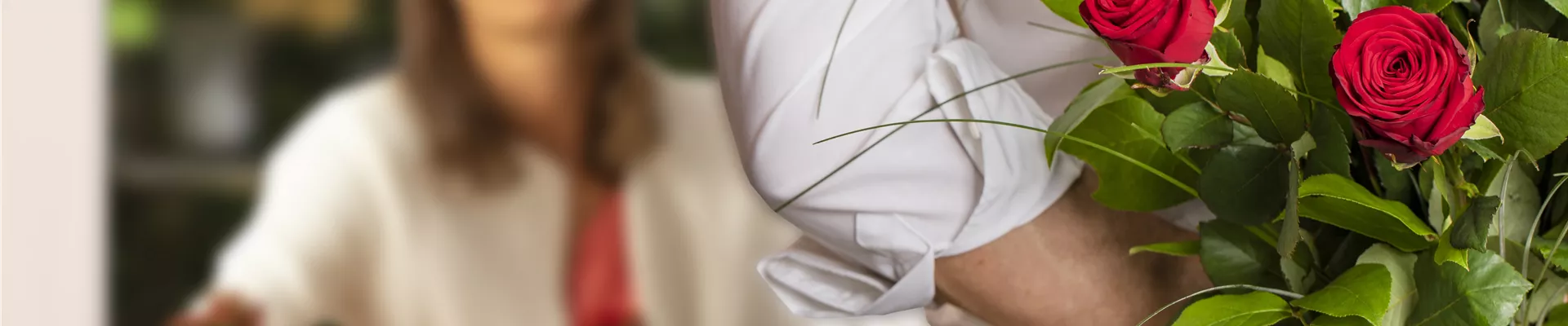 Mann überrascht Frau mit Strauß